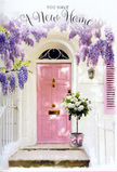 Here, a Chase Cross doorstep becomes a softly staged celebration of new beginnings, styled with the kind of care a local florist brings to an important occasion. A pale pink front door forms the focal point, its mellow hue exuding warmth and calm, as though it has been chosen specifically to make every arrival feel cherished. Above and around the frame, wisteria cascades in layered streams of lavender and lilac, each trailing cluster composed of dozens of tiny blossoms, creating a curtain of colour and an imagined perfume that seems to drift down like a sigh. The walls on either side are whitewashed, their faint texture catching the light while keeping the overall look clean and airy, like freshly painted façades along quiet Chase Cross lanes. On the top step, a grey metal bucket sits securely, filled to brimming with an arrangement of creamy white roses. The flowers appear plush and velvety, their petals unfolding in concentric rings that invite the hand to linger. Some roses are wide open, revealing soft centres, while others are in bud, suggesting new stories yet to unfold within this home. Delicate green foliage is threaded between the blooms, providing gentle contrast and a sense of movement, as though the bouquet has just been carried in from a garden nearby. A pink ribbon wraps around the bucket, tied into a tidy bow whose satin sheen echoes the door's pastel charm. Light passes through the veil of wisteria overhead, creating subtle dapples of brightness and shadow that dance across the step and lower half of the door. The composition feels serene, hopeful, and quietly festive-perfect for expressing congratulations to someone settling into a new home in Chase Cross, where this floral doorway becomes a symbol of welcome, comfort, and future happiness.
