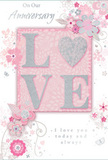 This tender anniversary card design offers a gentle celebration of lasting romance, its colours evoking the soft pastels often chosen for intimate bouquets in Chase Cross. At the centre, the word LOVE stands out in raised, pale lettering, dusted with fine, soft glitter that adds a muted sparkle. Instead of a traditional O, a shimmering silver heart forms part of the word, rich in texture and slightly more prominent than the surrounding letters, like a treasured charm resting above a vase on a windowsill. The overall palette blends pastel pinks with silvery greys and pearly whites, creating a tranquil background that feels like the sky just after dawn over the rooftops near Chase Cross Road. Around this focal word, delicate blooms unfold with a watercolor softness. These stylised flowers, in blush and mauve, have gently outlined petals and faint, shaded centres, giving them an airy, romantic quality. Slender stems and swirling tendrils weave between them, their lines flowing gracefully as if mimicking the natural curves of foliage in a hand-crafted bouquet from Chase Cross Florist. Tiny flourishes-petals in mid-air, swirling curls, and scarcely visible butterflies-introduce a sense of motion and playfulness, reminiscent of a light spring breeze moving through local gardens. The phrases On Our Anniversary and I love you today and always appear in a refined, understated script, carefully placed so they sit comfortably among the florals, as though held in place by the blossoms themselves. The overall composition feels calm, sincere, and deeply affectionate, a keepsake that quietly honours shared memories and the ongoing journey of love in everyday life across the Chase Cross area.